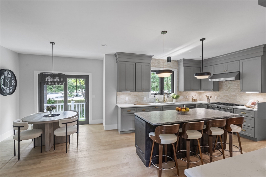 11 Avon Lane Natick, MA 01760 - Photo 10 of 21 a kitchen with stainless steel appliances granite countertop a kitchen island hardwood floor and a view of living room