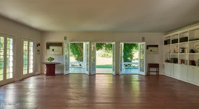 a view of a balcony with dining table and chairs with wooden floor