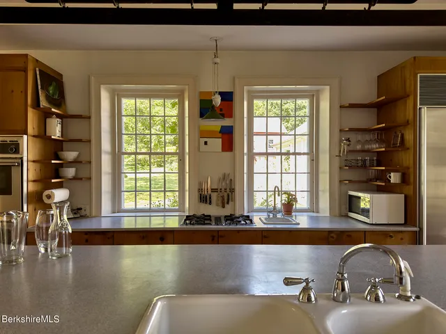 a living room with furniture and two window