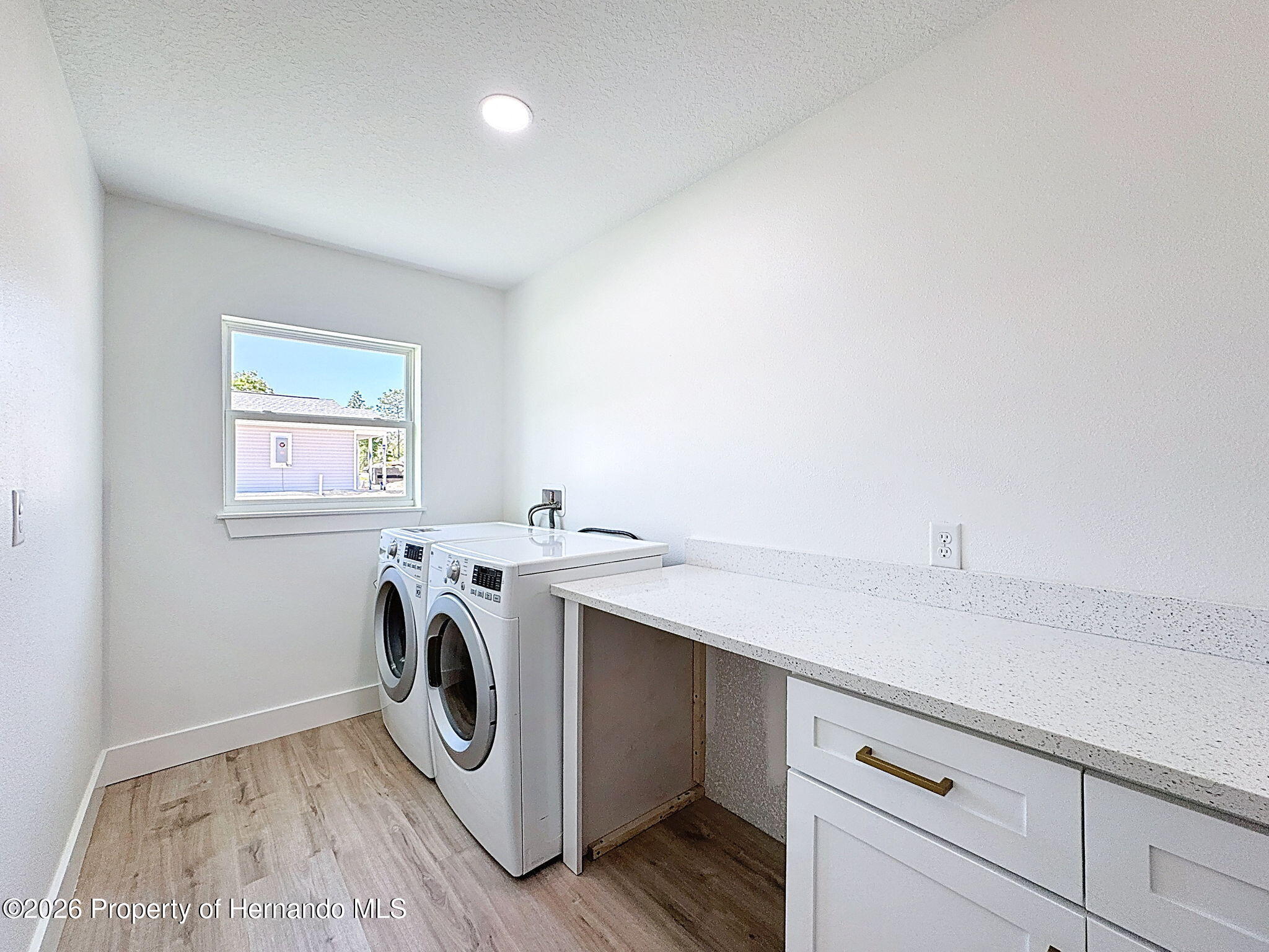 8988 Waterbird Way Weeki Wachee, FL 34613 - Photo 20 of 42 a utility room with dryer and washer