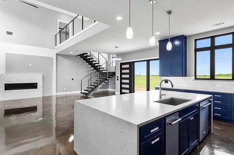 186 Martin Lane Sadler, TX 76264 - Photo 13 of 39 a kitchen with stainless steel appliances granite countertop a sink a oven and a wooden cabinets