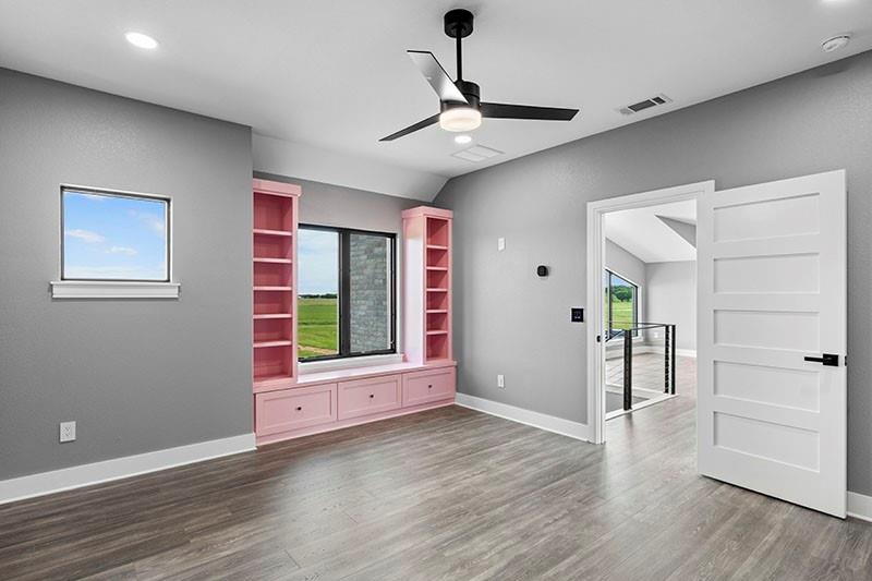 186 Martin Lane Sadler, TX 76264 - Photo 25 of 39 a view of an empty room with wooden floor and a window