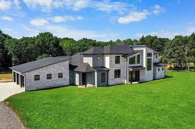 a front view of house with yard and green space