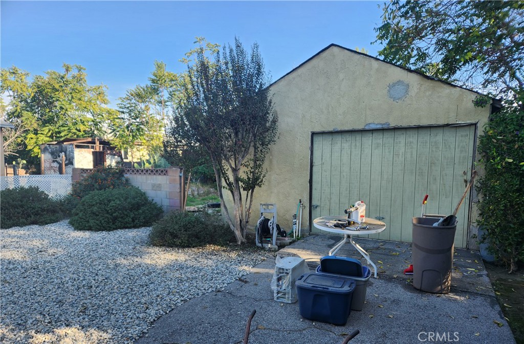 13754 Weidner Street Pacoima, CA 91331 - Photo 5 of 16 a view of a patio with table and chairs and a fire pit