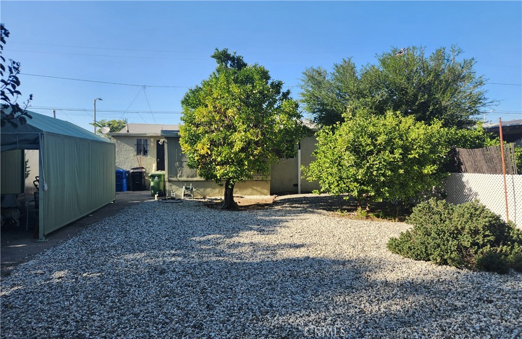13754 Weidner Street Pacoima, CA 91331 - Photo 7 of 16 a view of a yard with a tree