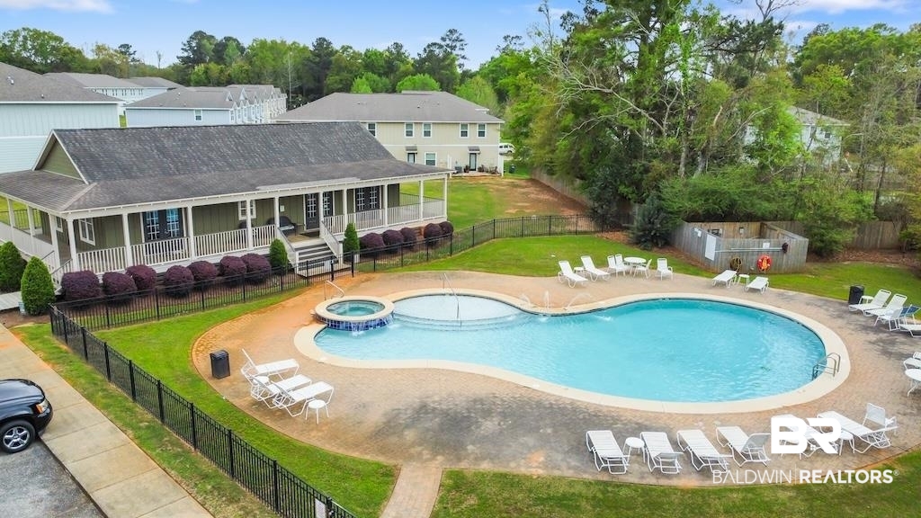 25806 Pollard Road, Unit 27 Daphne, AL 36526 - Photo 8 of 46 Combined pool / hot tub featuring a fenced backyard, a patio, a large porch, and view of wooded area
