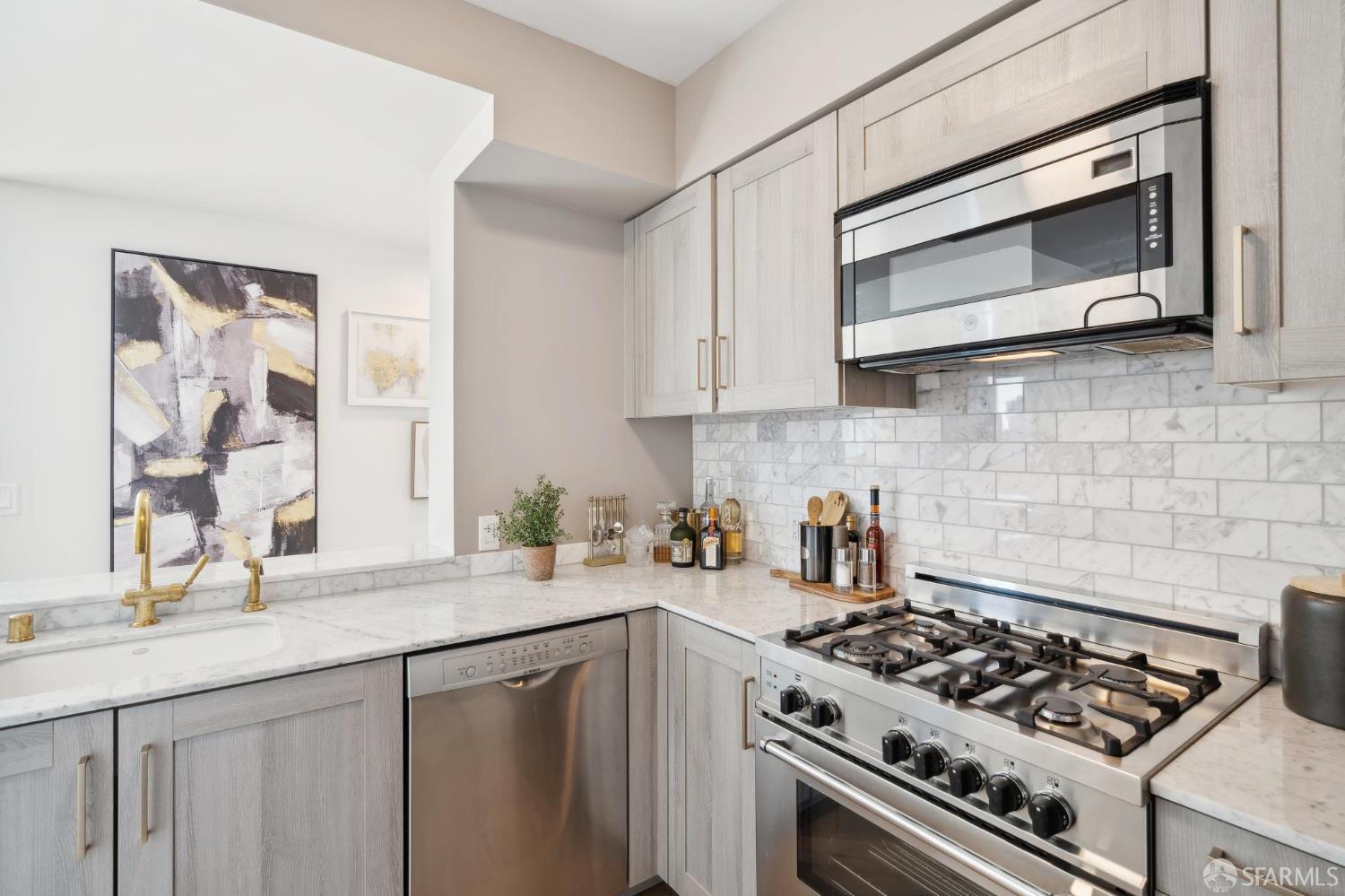 401 Harrison Street, Unit 9H San Francisco, CA 94105 - Photo 13 of 44 a kitchen with stainless steel appliances a stove a sink and a microwave