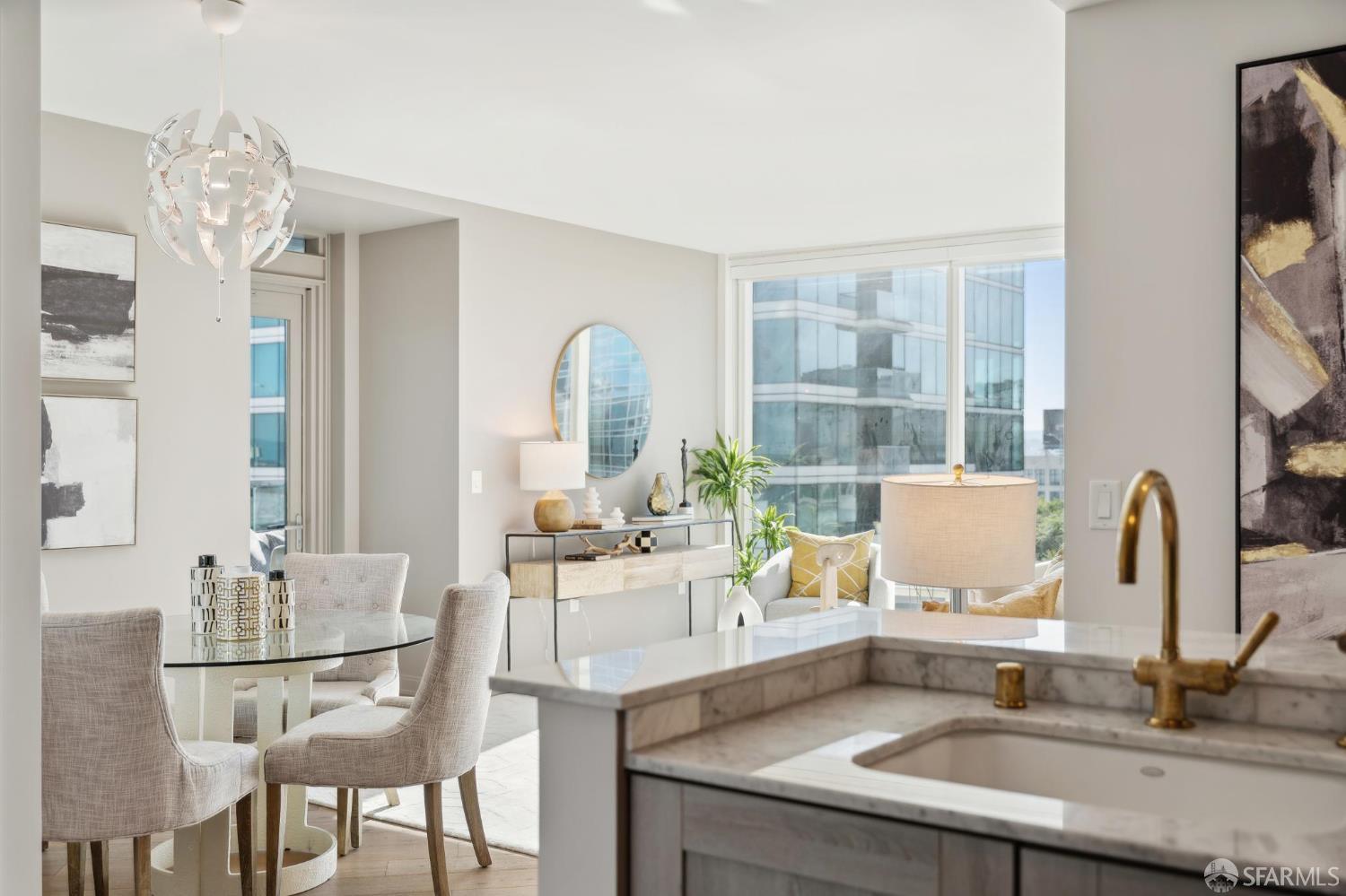 401 Harrison Street, Unit 9H San Francisco, CA 94105 - Photo 14 of 44 a kitchen with a table chairs and flat screen tv