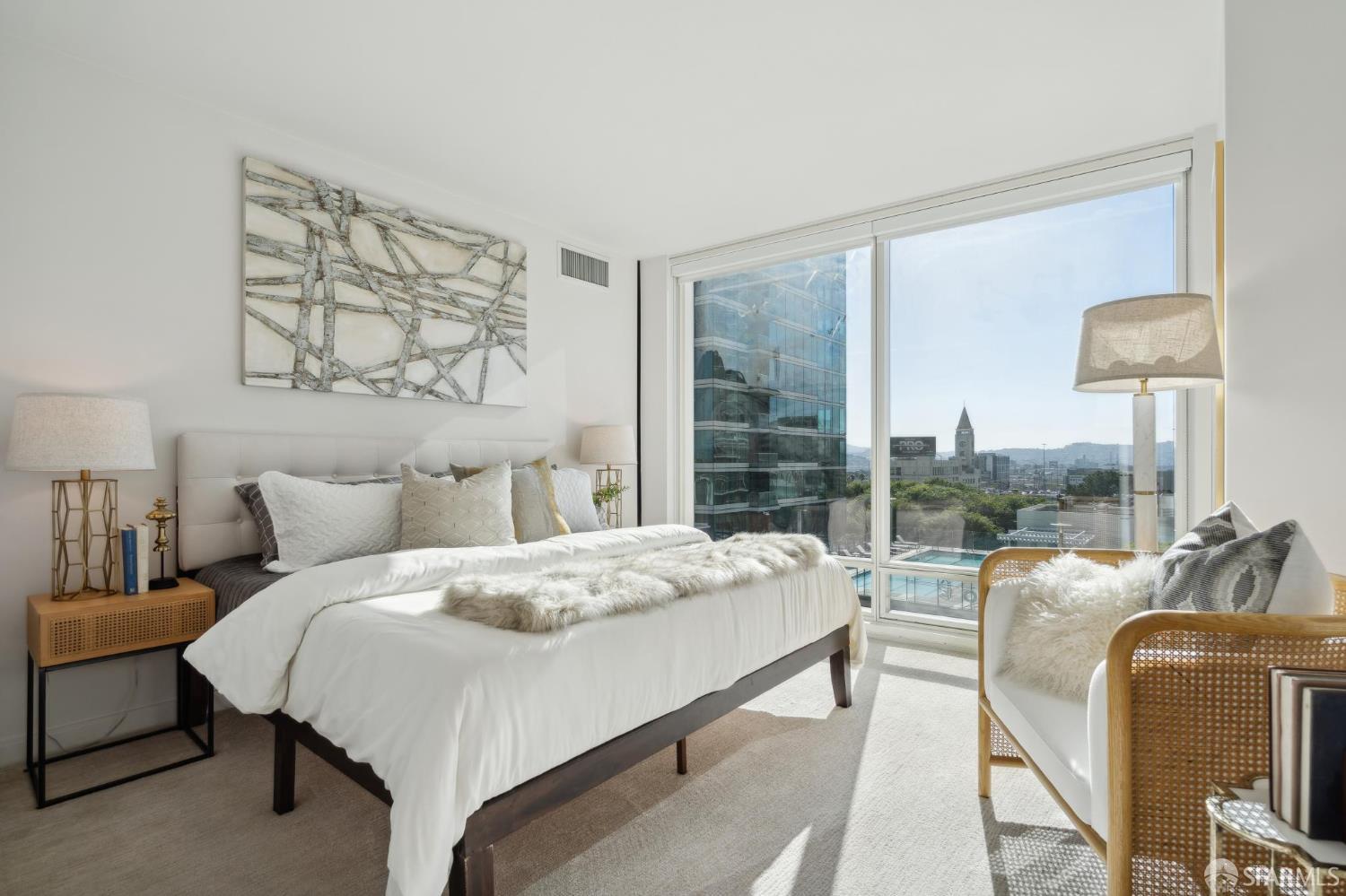 401 Harrison Street, Unit 9H San Francisco, CA 94105 - Photo 16 of 44 a bedroom with a bed and a lamp next to a window