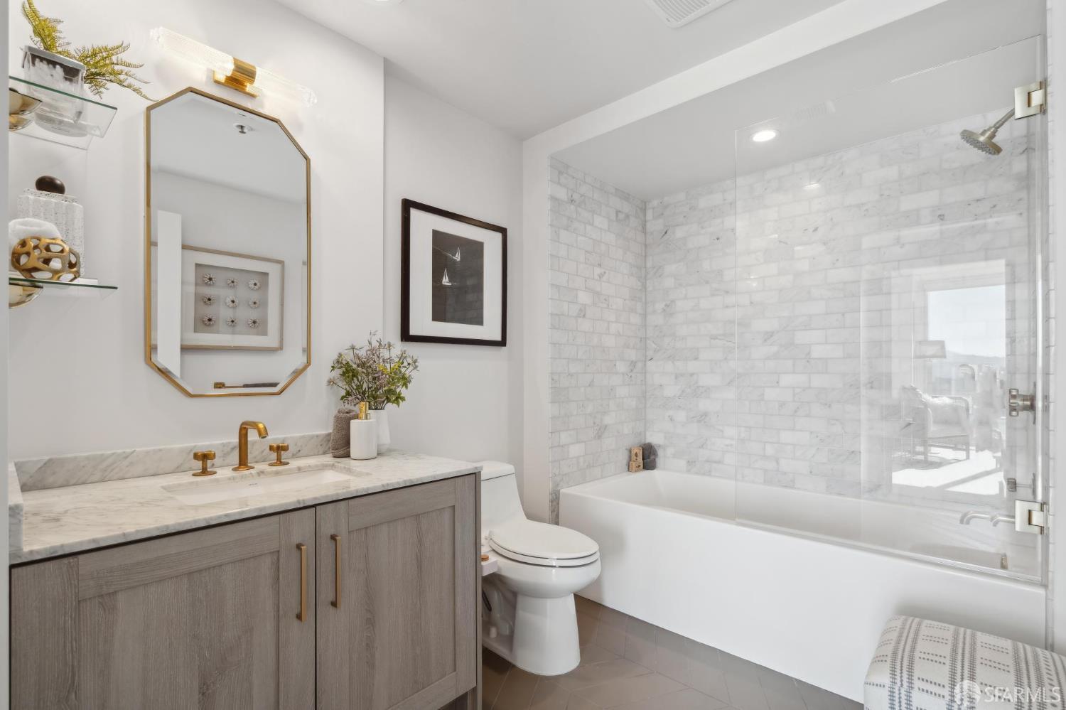 401 Harrison Street, Unit 9H San Francisco, CA 94105 - Photo 20 of 44 a bathroom with a granite countertop sink toilet and shower