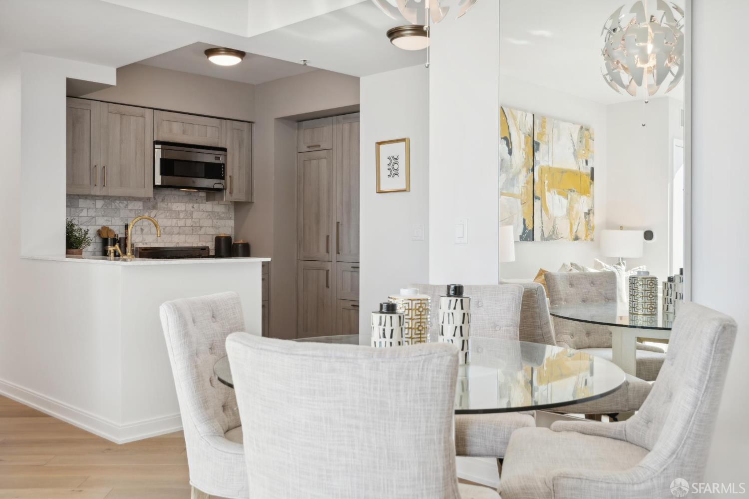 401 Harrison Street, Unit 9H San Francisco, CA 94105 - Photo 10 of 44 a dining table chair and fireplace