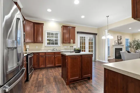 a kitchen with wooden cabinets stainless steel appliances and a window