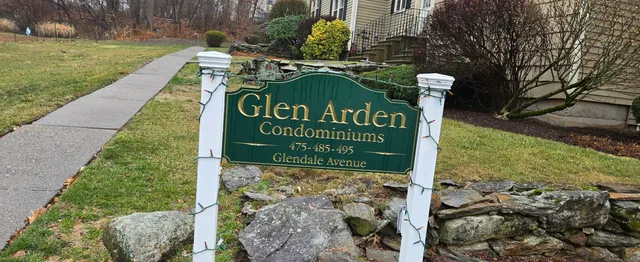 a sign broad in front of a brick building