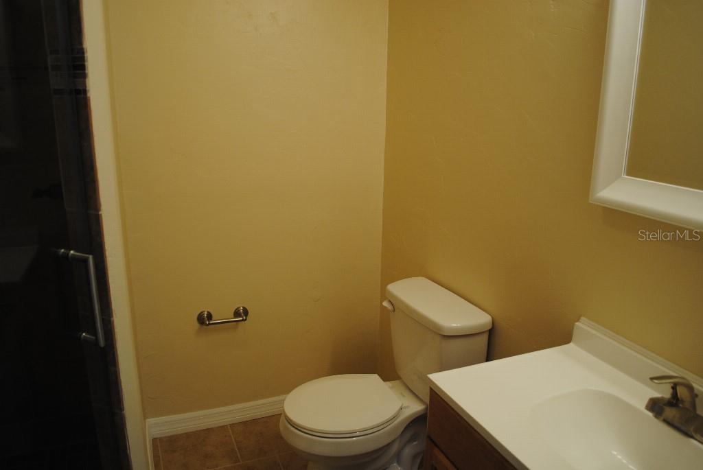 2829 Northwest 40th Place Gainesville, FL 32605 - Photo 11 of 15 a white toilet sitting next to a bathroom sink