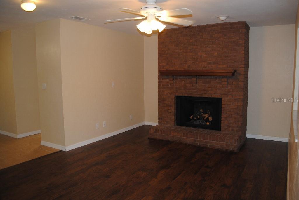 2829 Northwest 40th Place Gainesville, FL 32605 - Photo 2 of 15 a room with a fireplace and a chandelier