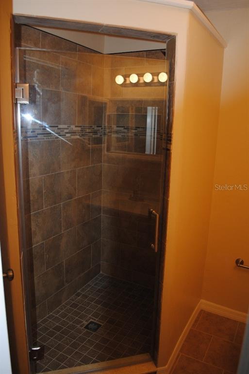 2829 Northwest 40th Place Gainesville, FL 32605 - Photo 10 of 15 a bathroom with a glass shower door