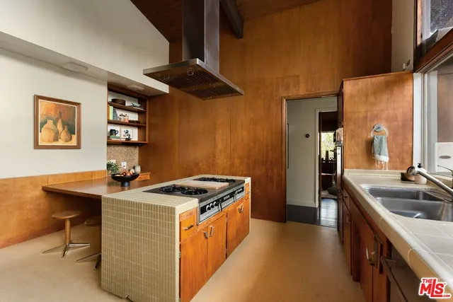 a kitchen that has a sink and a stove