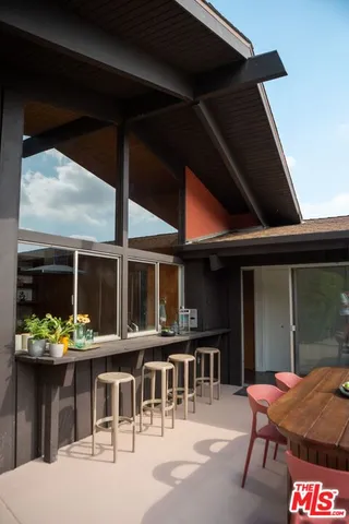 a outdoor seating area with a table and chairs