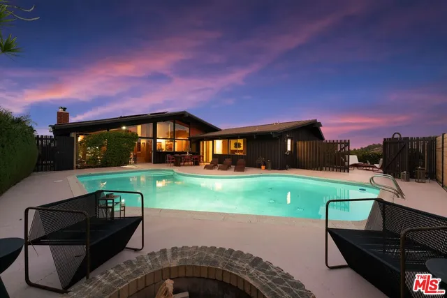 a house view with a sitting space and garden