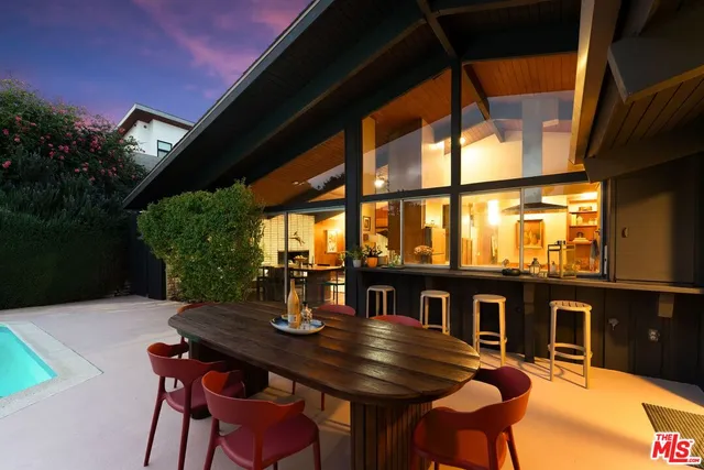 a view of a patio with table and chairs and potted plants