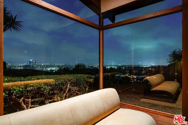 a view of roof deck with seating space and trees in the background