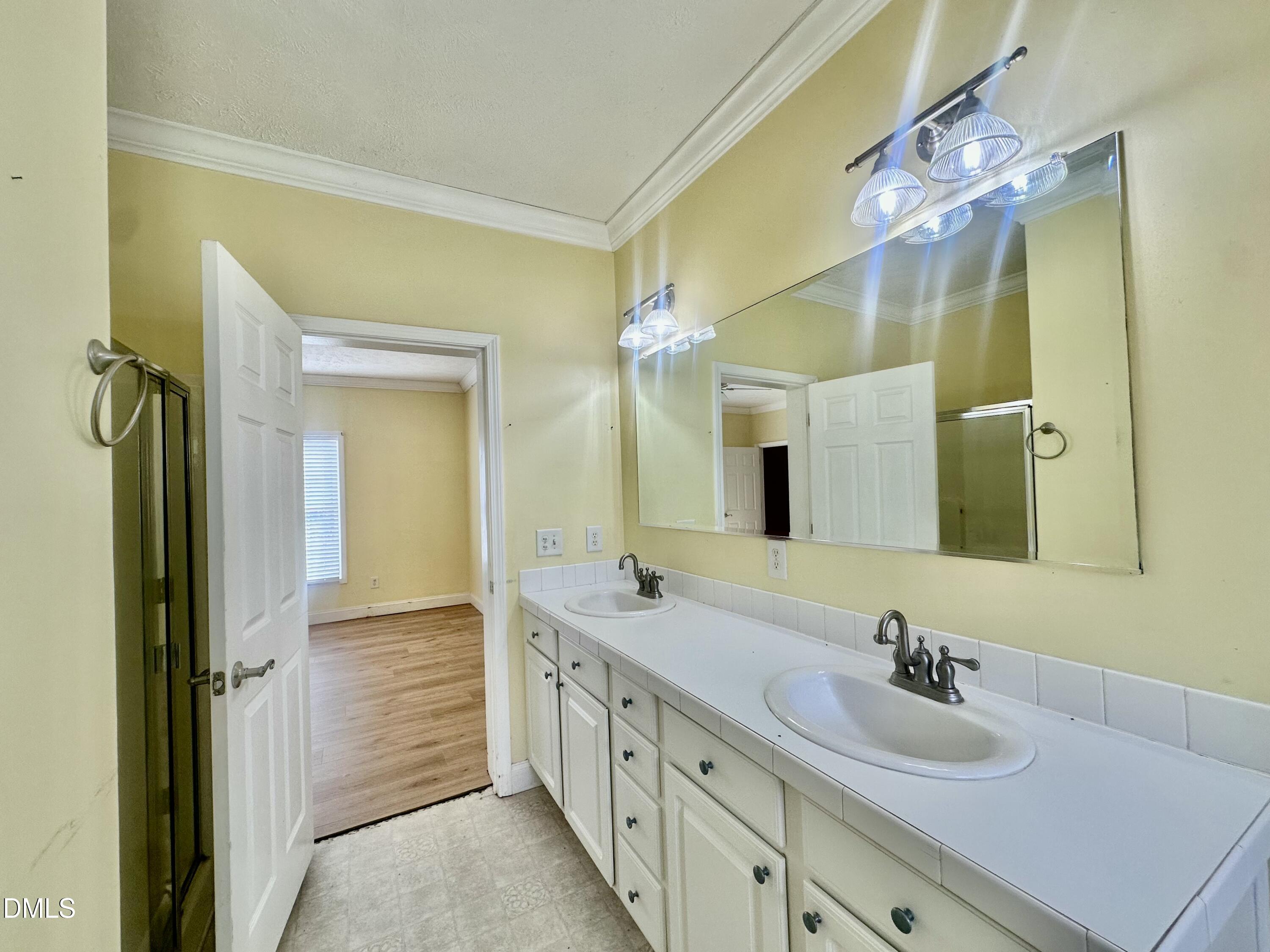 155 Collin Drive Roxboro, NC 27574 - Photo 9 of 20 a spacious bathroom with a double vanity sink and a mirror
