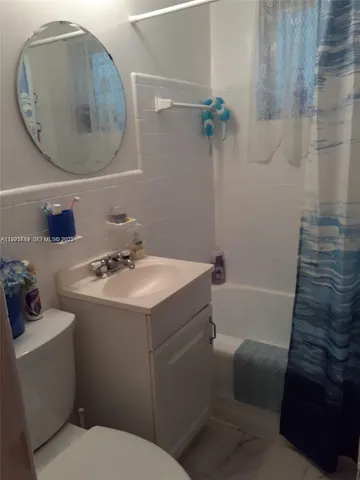 a bathroom with a sink toilet and tub