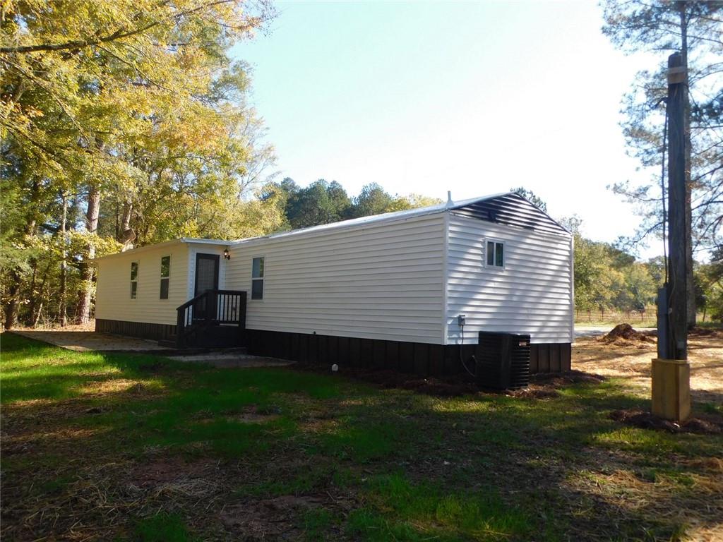 1101 Boswell Road Union Point, GA 30669 - Photo 14 of 60 a view of a back yard of the house