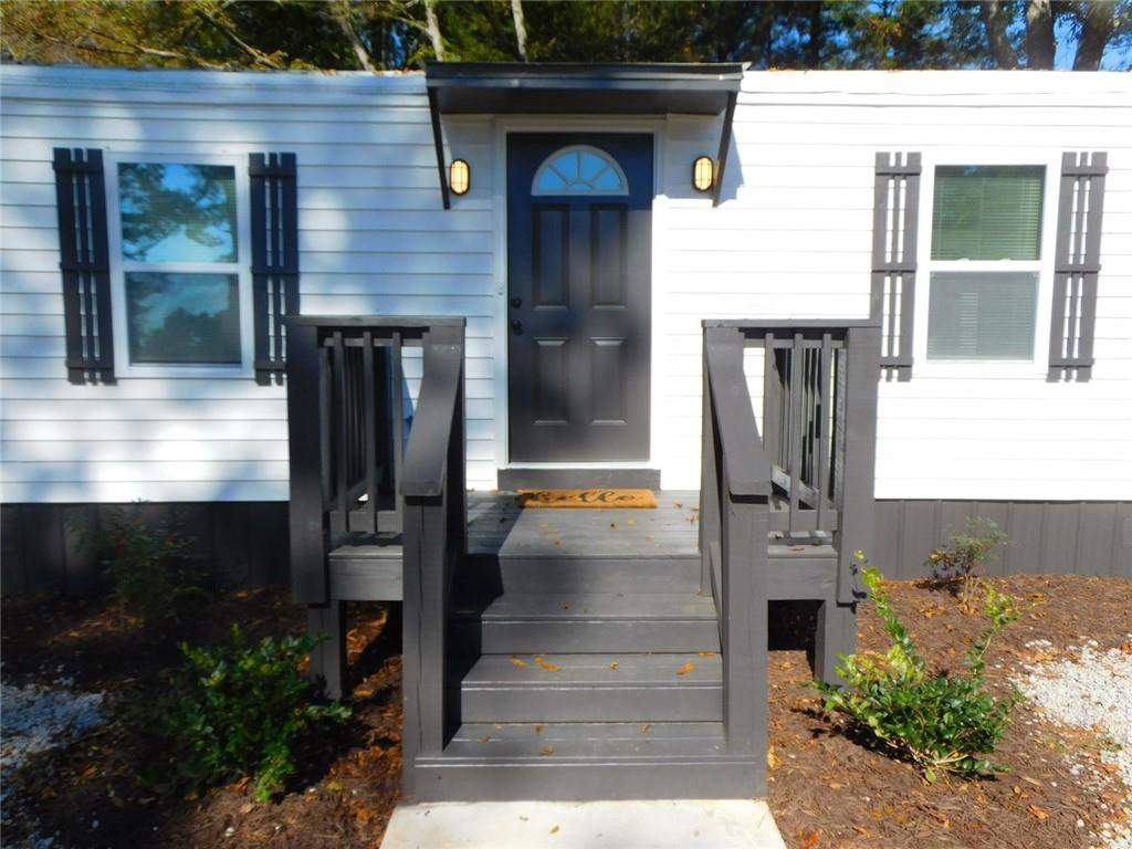 1101 Boswell Road Union Point, GA 30669 - Photo 15 of 60 a front view of a house with a yard
