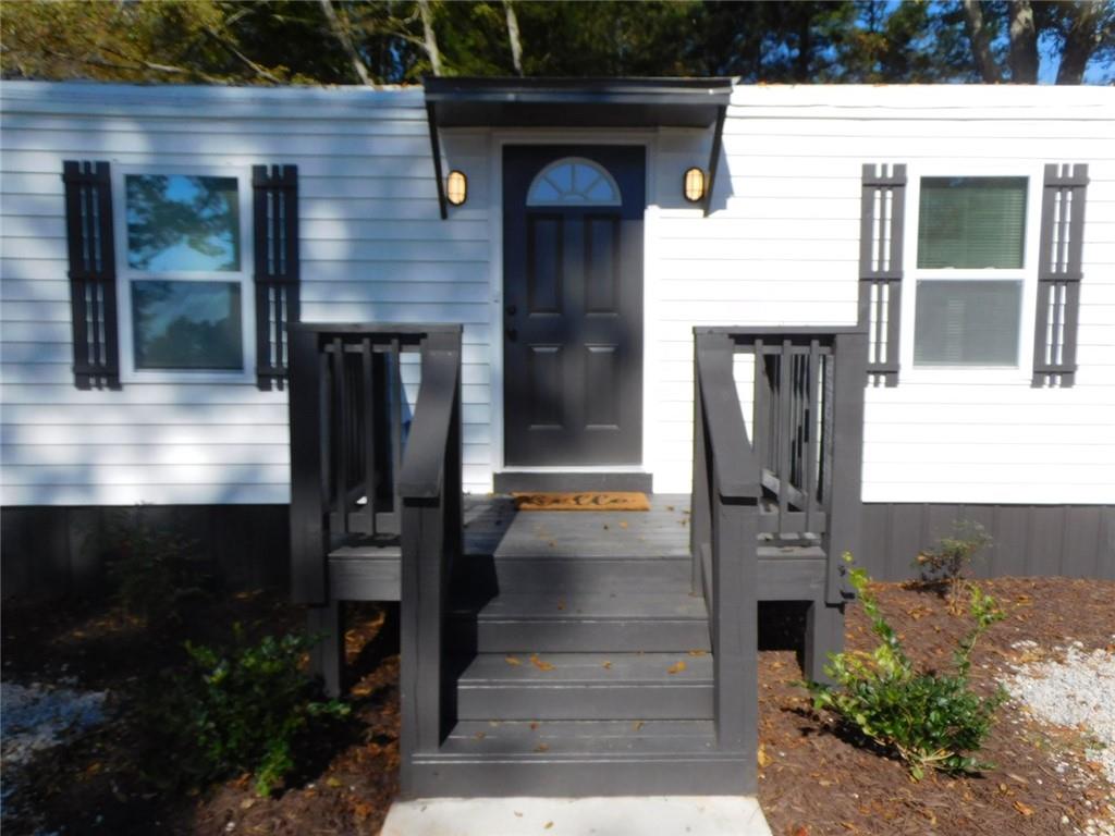 1101 Boswell Road Union Point, GA 30669 - Photo 16 of 60 a front view of a house with a garden