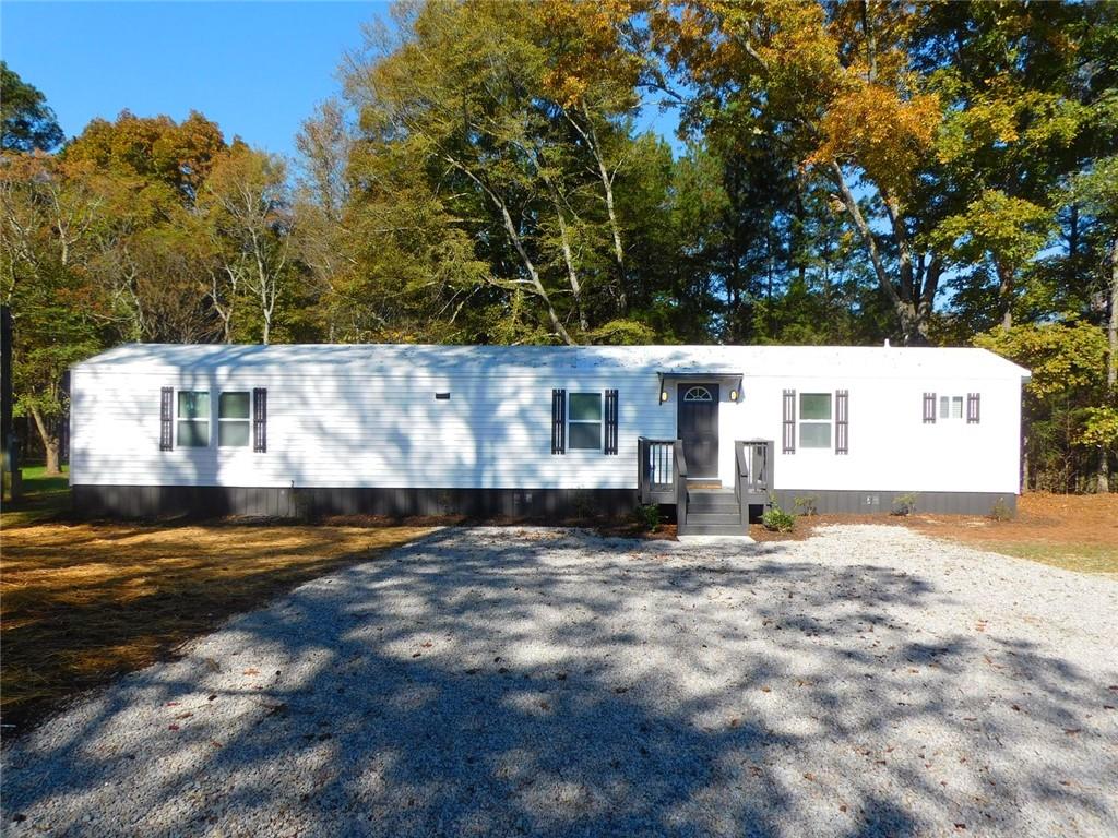 1101 Boswell Road Union Point, GA 30669 - Photo 17 of 60 a view of a house with a yard