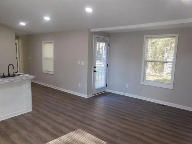 a kitchen with stainless steel appliances granite countertop a stove a microwave and a white cabinets