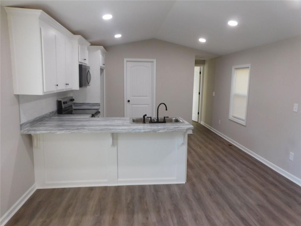 1101 Boswell Road Union Point, GA 30669 - Photo 29 of 60 a bathroom with a sink and a mirror