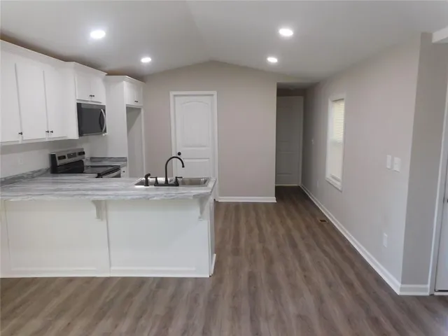 a close view of a sink a faucet and appliance in the kitchen