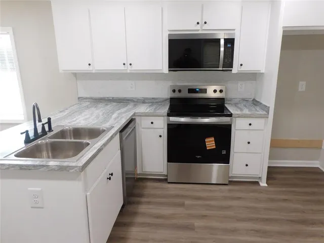 a stove top oven sitting inside of a kitchen