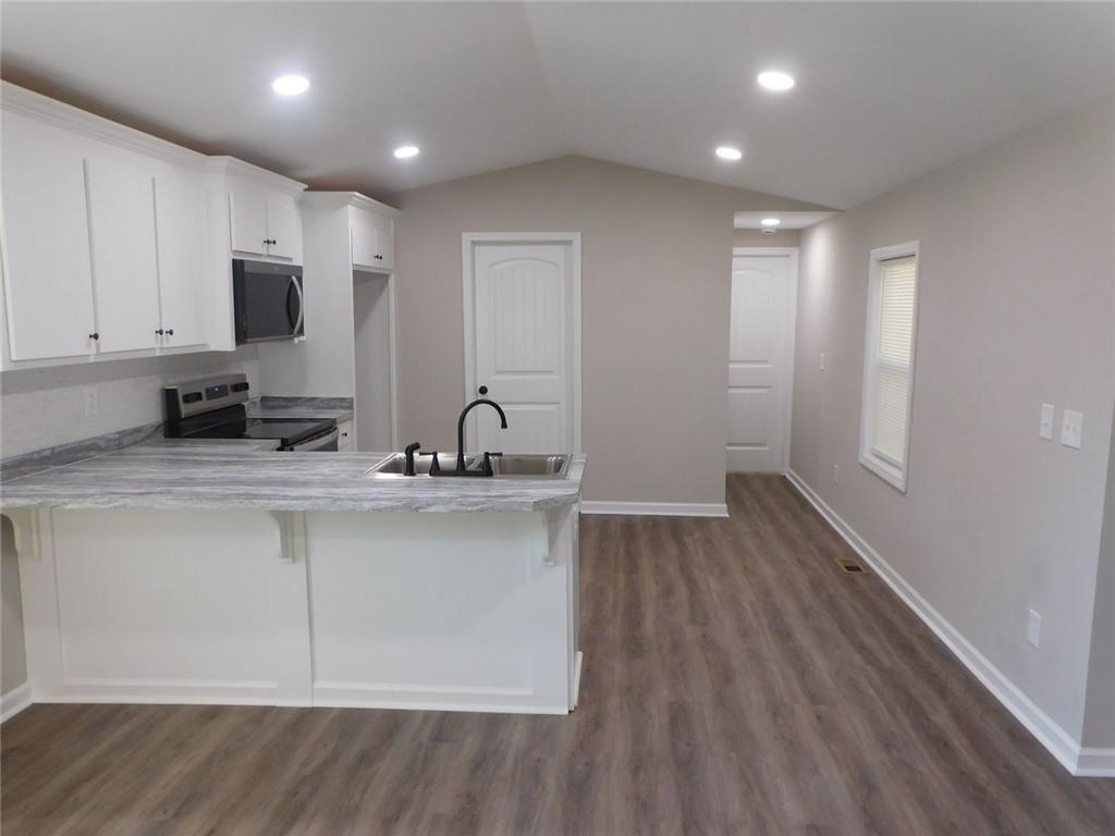 1101 Boswell Road Union Point, GA 30669 - Photo 38 of 60 a view of kitchen with stainless steel appliances granite countertop a sink and cabinets