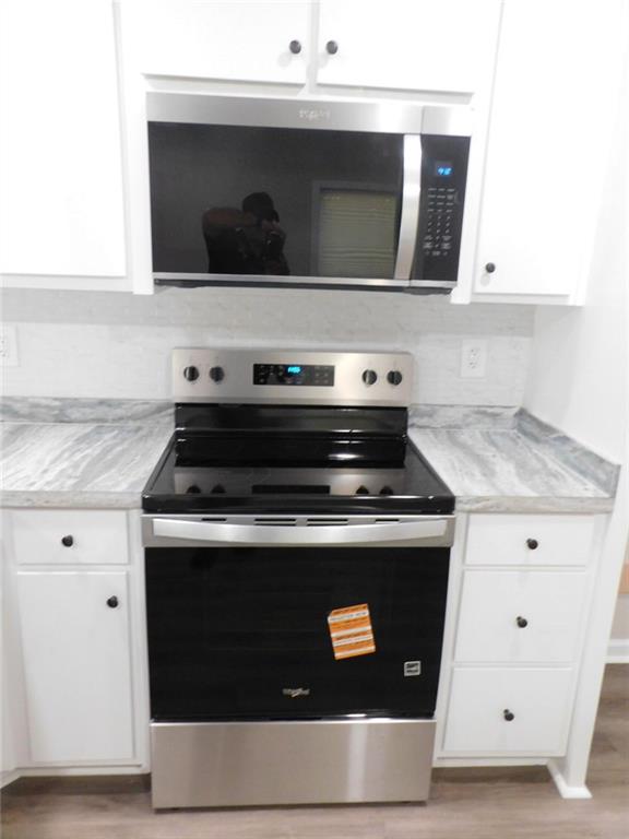 1101 Boswell Road Union Point, GA 30669 - Photo 40 of 60 a stove top oven sitting inside of a kitchen