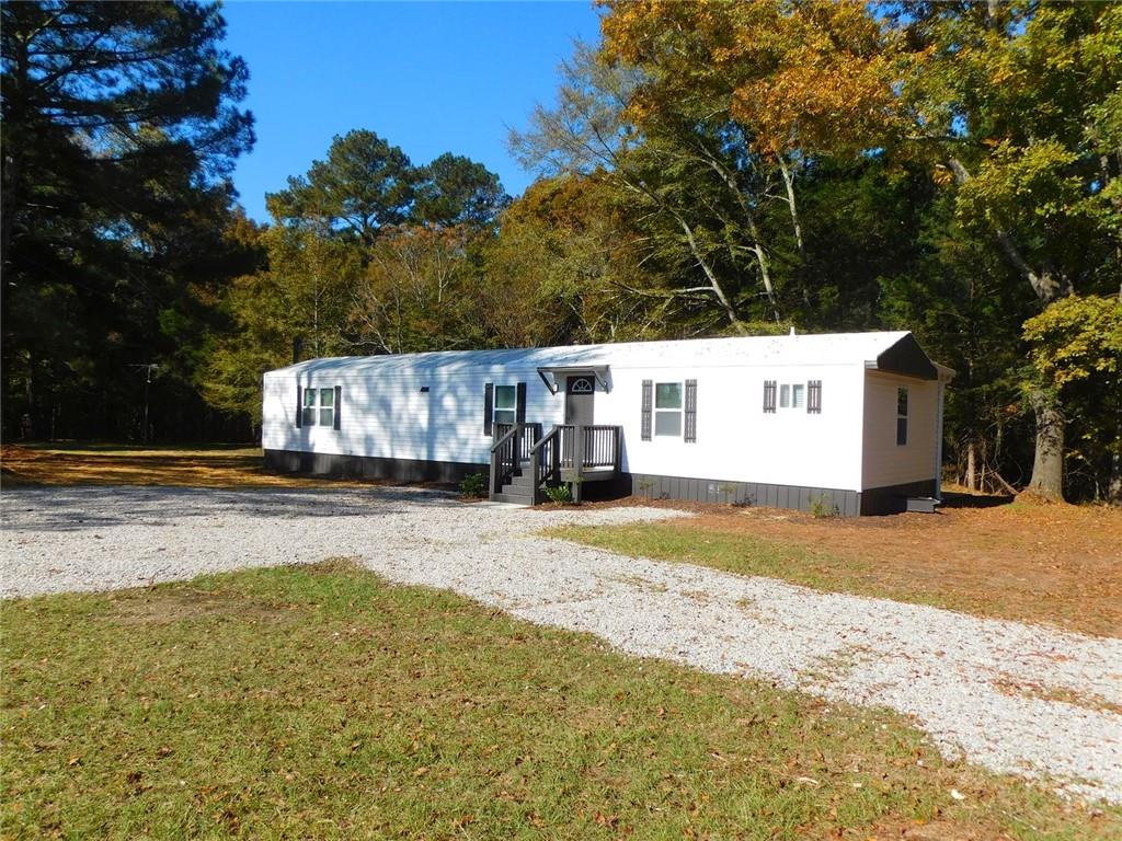 1101 Boswell Road Union Point, GA 30669 - Photo 4 of 60 a view of a house with snow on the road