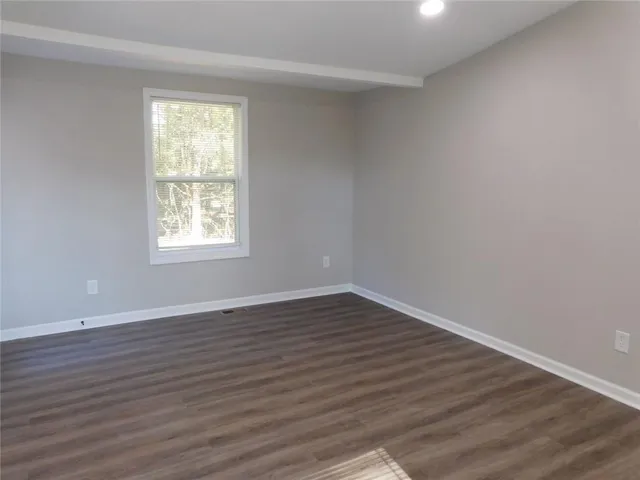 a room with water heater and wooden cabinets