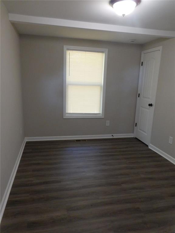 1101 Boswell Road Union Point, GA 30669 - Photo 44 of 60 a view of an empty room with wooden floor and a window