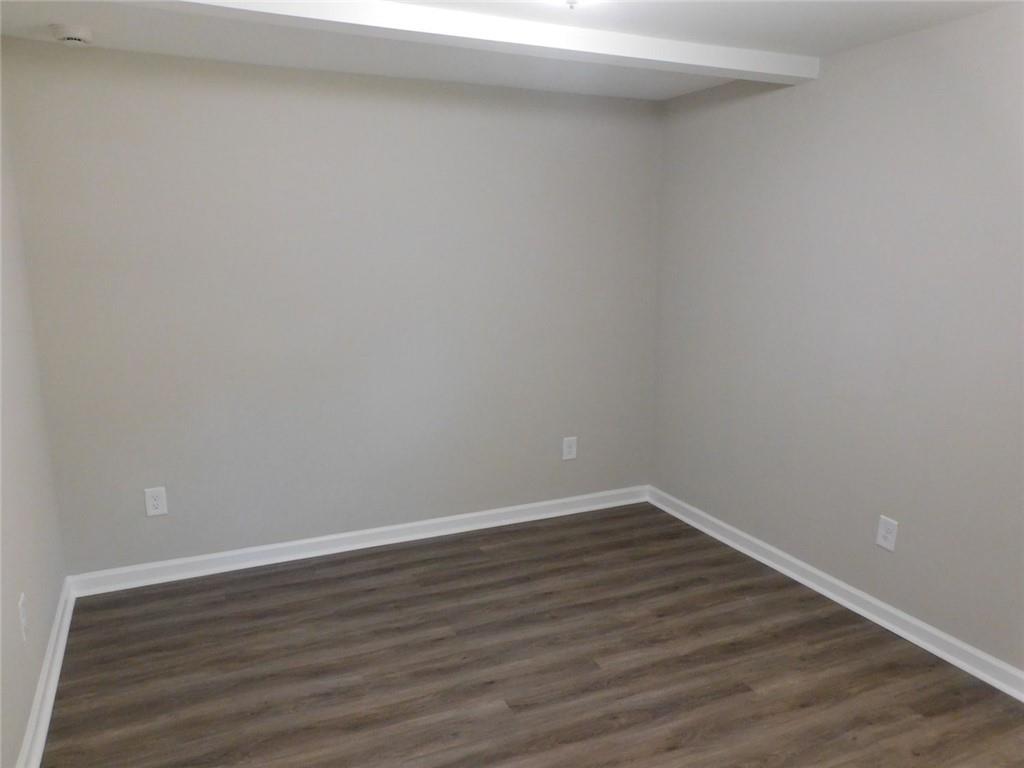 1101 Boswell Road Union Point, GA 30669 - Photo 46 of 60 a view of an empty room with wooden floor