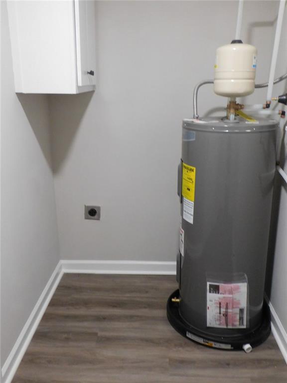 1101 Boswell Road Union Point, GA 30669 - Photo 50 of 60 a room with water heater and wooden cabinets