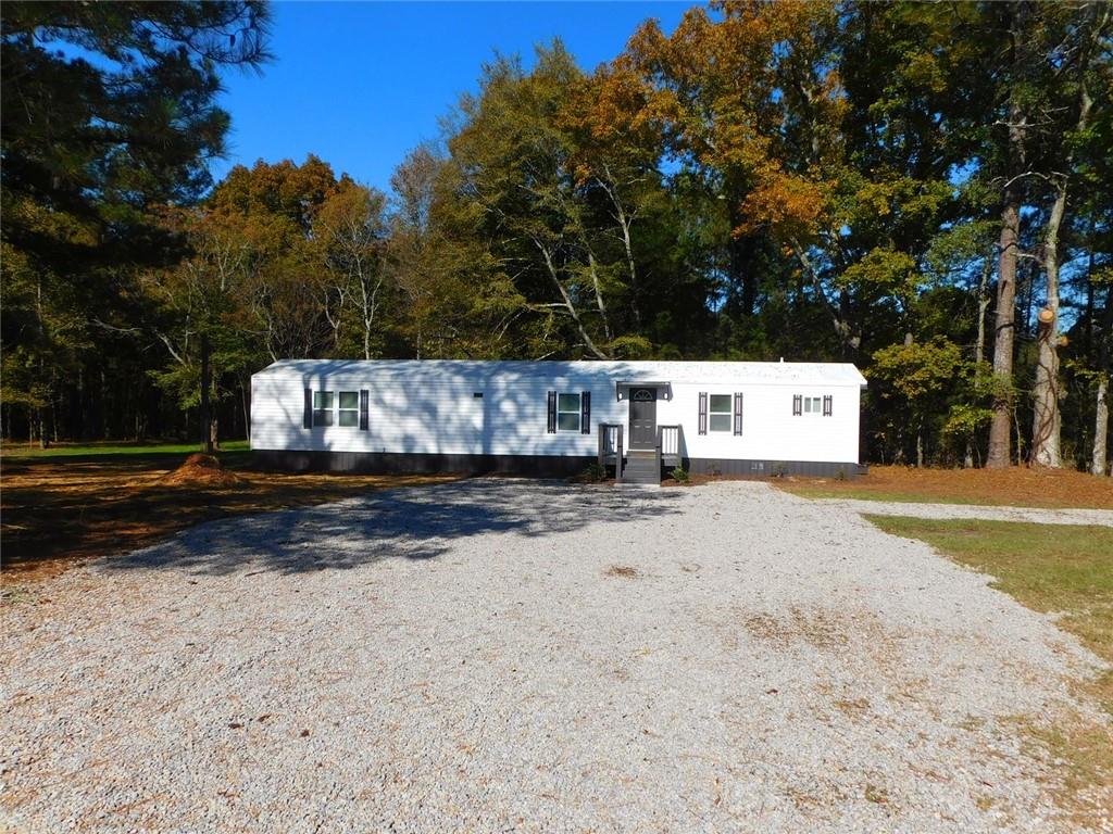 1101 Boswell Road Union Point, GA 30669 - Photo 5 of 60 a view of street with large trees