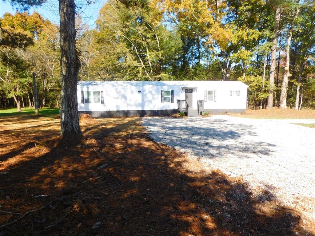 1101 Boswell Road Union Point, GA 30669 - Photo 6 of 60 a view of a yard with plants and trees