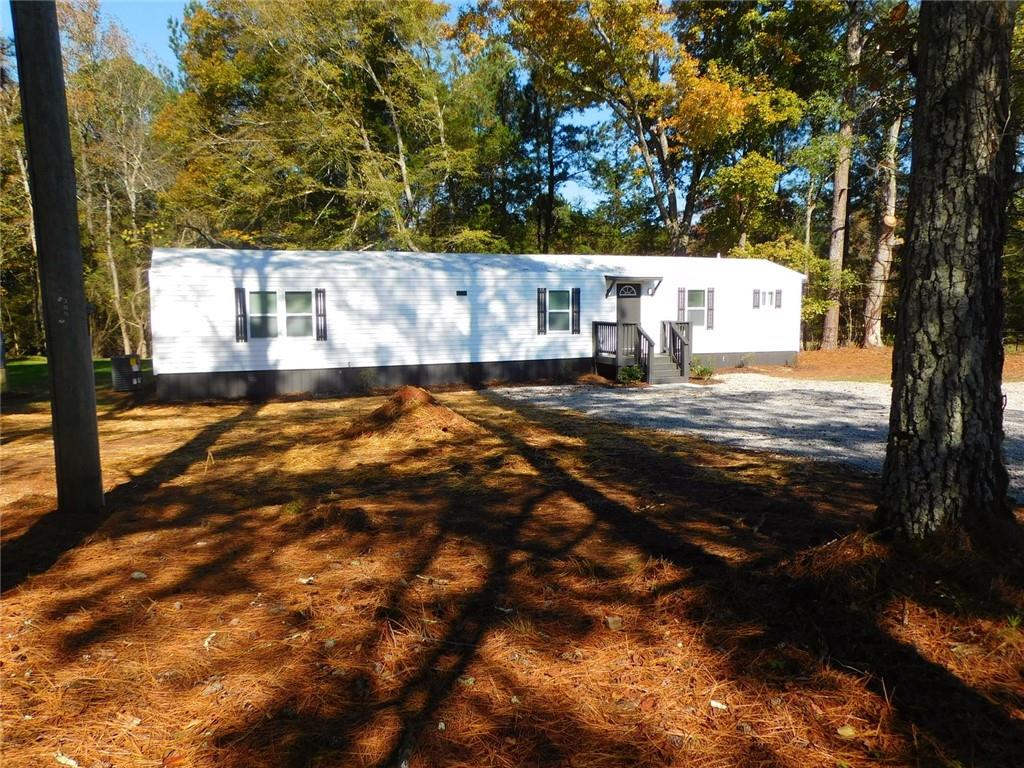 1101 Boswell Road Union Point, GA 30669 - Photo 7 of 60 a view of a house with a yard