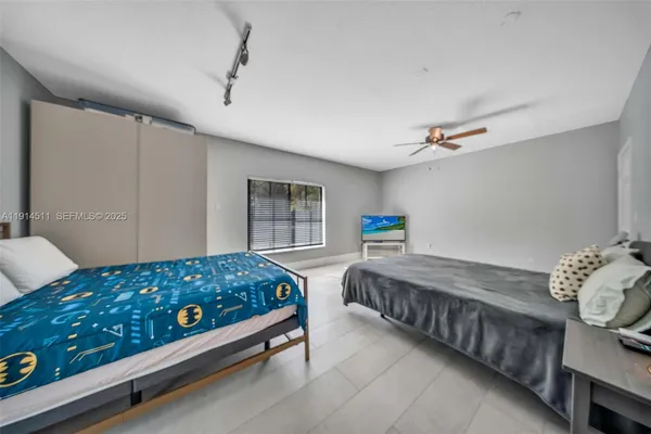 a large kitchen with stainless steel appliances kitchen island granite countertop a large counter top a refrigerator and cabinets