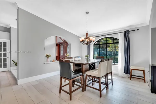 a view of a dining room with furniture water view and a floor to ceiling window