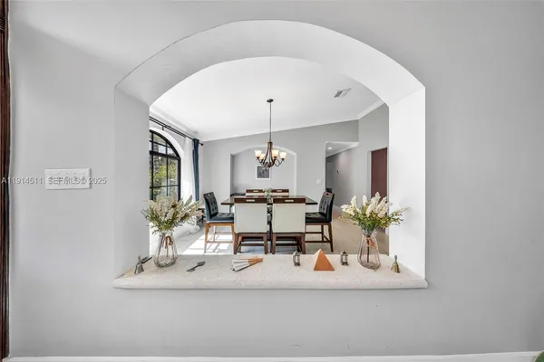 a living room with furniture a mirror and a large window