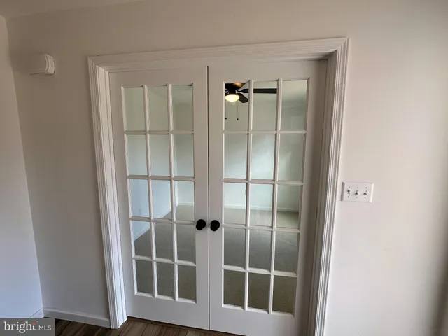 a view of staircase with sliding door and wooden floor
