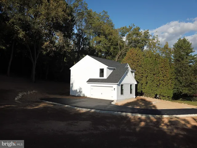 a view of a white house with a yard